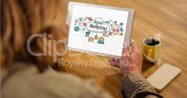 Businesswoman holding tablet PC with digital marketing sign