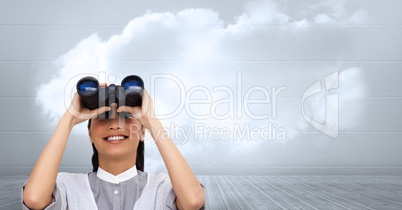 Businesswoman using binoculars against cloudy sky