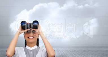 Businesswoman using binoculars against cloudy sky