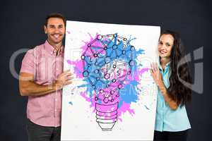 Portrait of happy business people showing creative light bulb on placard