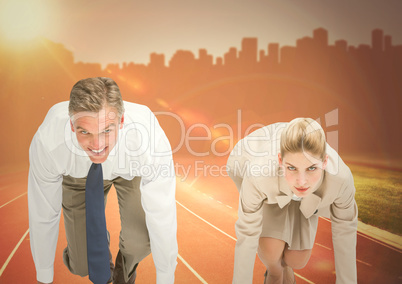 Business woman at start line against orange flare and skyline