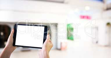 Hands with tablet in the shopping centre