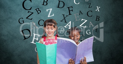 Digitally generated image of girls holding books with letters flying against green background