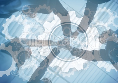 Business team putting hands together with gear graphic overlay