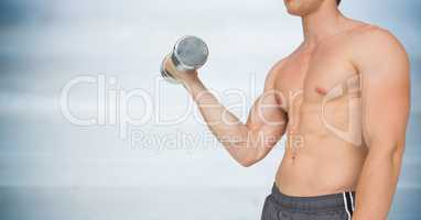 Man mid section weightlifting against blurry blue wood panel