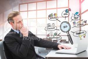 Digitally generated image of businessman using laptop in office