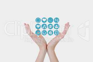 Digital composite image of hands with medical icons