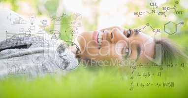 Digital composite image of happy woman lying on grass with equations