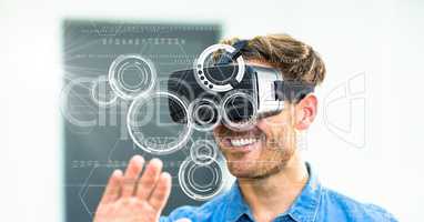 Digital composite image of smiling man using VR glasses