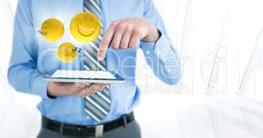 Business man mid section with tablet and emojis with flares against white window