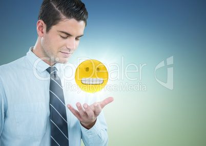 Business man with hand open and emoji with flare against blue green background