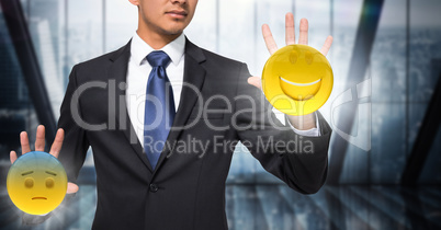 Business man mid section with flares and emojis on hands against dark blurry window