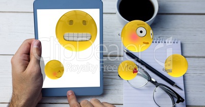 Emojis coming out from tablet PC while man using it