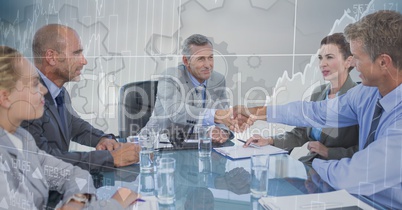 Business meeting with behind gear and chart graphic overlay against grey background