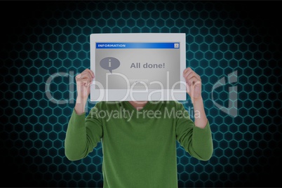 Man holding placard with computer screen in front of face