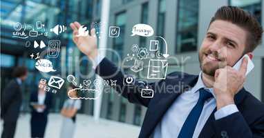 Businessman using mobile phone by icons representing multi tasking
