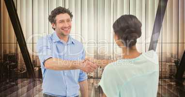 Male and female colleagues shaking hands in office