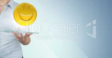 Business woman mid section with tablet and emoji and flare against blue background