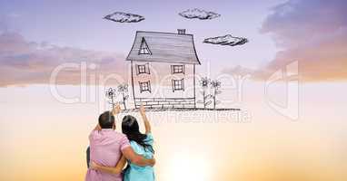Digital composite image of couple pointing at dream house