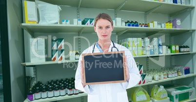 Doctor showing blank slate in pharmacy