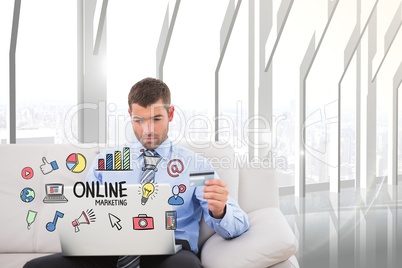 Digital composite image of businessman shopping online on laptop with icons in foreground