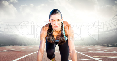 Female runner on track against flares