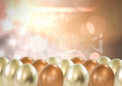 Easter eggs in front of sparkling lights gold