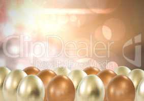 Easter eggs in front of sparkling lights gold