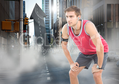 Male runner with headphones on arrow shaped road in street