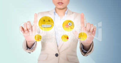 Business woman with emojis and flares between hands against blue background