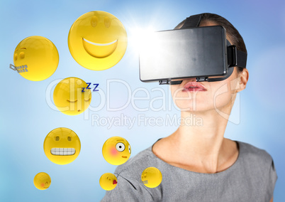 Woman in VR with emojis and flares against blue background