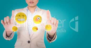 Business woman with emojis and flares between hands against blue background
