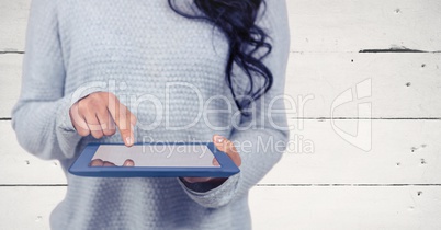 Woman mid section with tablet against white wood panel