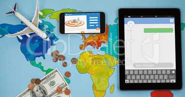 Overhead view of smart phone and tablet computer on world map with currency