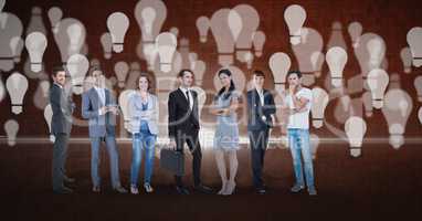 Digital composite image of business people with light bulb background