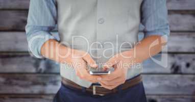 Man mid section with phone against blurry blue wood panel