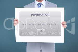Midsection of businessman holding information sign