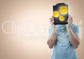 Man tablet over face showing emojis with flares against cream background