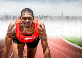 Male runner on track against blurry skyline
