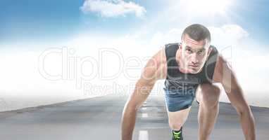 Male runner on road against sky and sun with flare