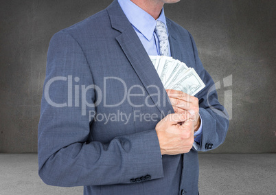 Business man mid section putting money away against grey wall