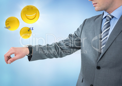 Business man with hand out and emojis with flares against blue background
