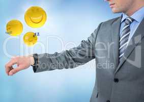 Business man with hand out and emojis with flares against blue background