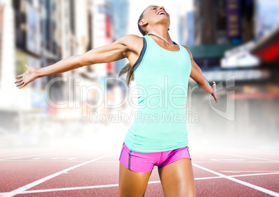 Female runner on track against blurry city