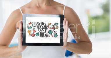 Midsection of woman showing various icons on screen of digital tablet