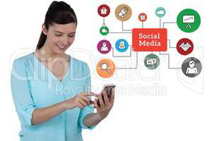 Woman using mobile phone while standing by social media diagram against white background