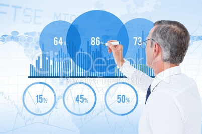 Digital composite image of businessman making chart on screen