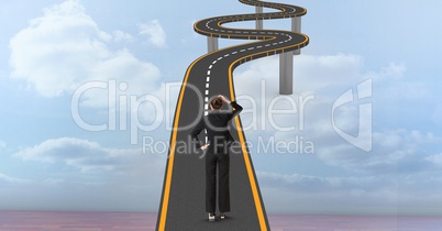 Digital composite image of confused businesswoman on curvy bridge