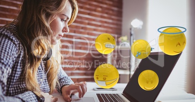 Woman using laptop with various emojis