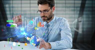 Digital composite image of businessman touching icons at desk